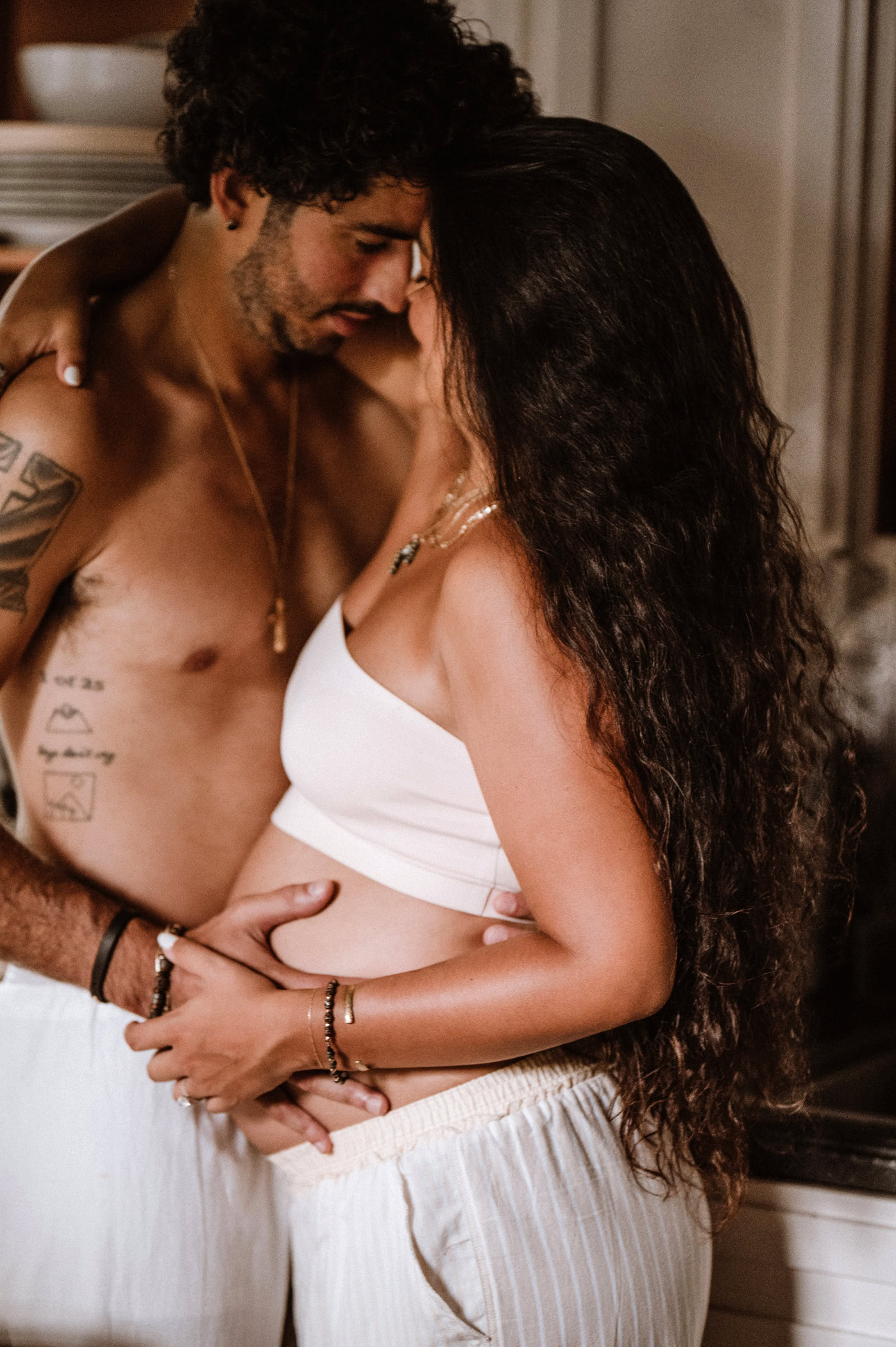 Artistic maternity boudoir portrait celebrating pregnancy through elegant fine art photography.