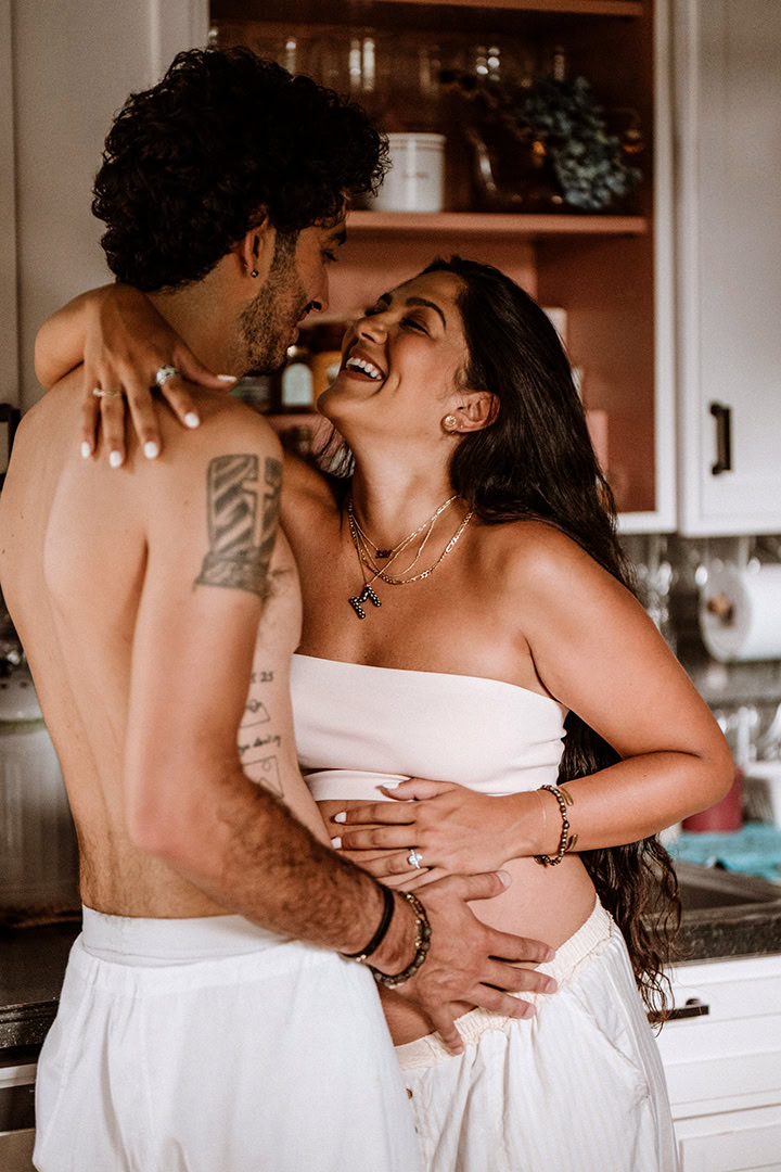 Expecting couple embracing during a lifestyle maternity photography session in Connecticut.